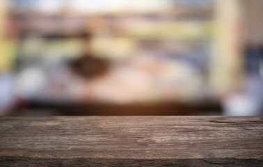 Empty dark wooden table in front of abstract blurred bokeh background of restaurant . can be used for display or montage your products.Mock up for space.