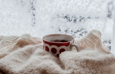 Obraz na płótnie Canvas Warm cup of tea with window