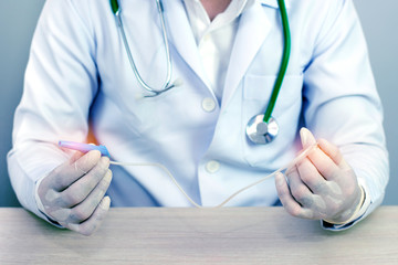 hands and remedial catheter. Hygienic care of the patient.(blue tone concept)