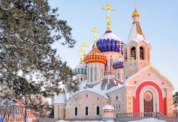 Fototapeta na wymiar Moscow city historical skyline white winter wonderland street view of orthodox church with colorful dome and golden cross red sunset cold season landscape background russian winter scene