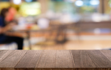 Empty dark wooden table in front of abstract blurred bokeh background of restaurant . can be used for display or montage your products.Mock up for space.