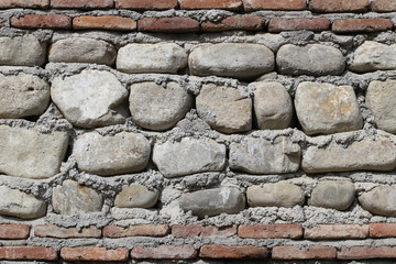 Wall from stones and bricks