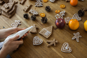 Christmas gingerbread icing decorating process. Homemade sweet cookies
