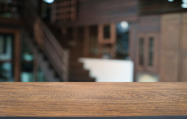 Empty dark wooden table in front of abstract blurred bokeh background of restaurant . can be used for display or montage your products.Mock up for space.