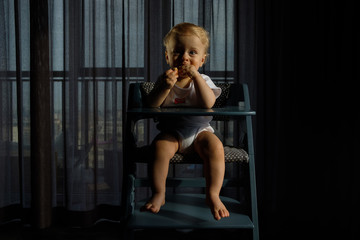 Feeding a baby in a highchair. Food Dirty Kid