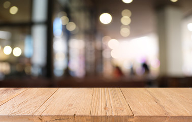 Empty dark wooden table in front of abstract blurred bokeh background of restaurant . can be used for display or montage your products.Mock up for space.