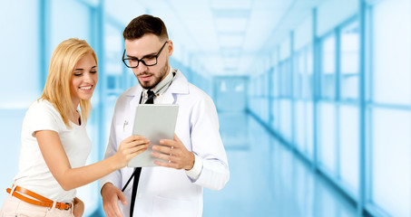 Doctor talking to patient in the hospital. The happy patient is listening to explanation from the...