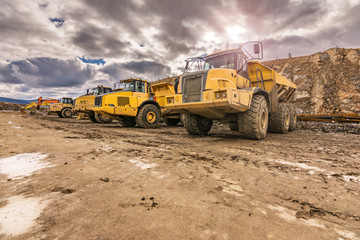 Large trucks in an open pit mine