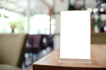 Menu frame standing on wood table in Bar restaurant cafe. space for text marketing promotion.