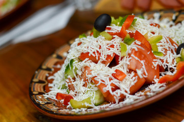 Picture of a traditional Bulgarian salad prepared from tomatoes, cucumbers, pepper and cheese.Shopska salad.