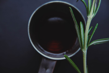 Tea in the mug with rosemary