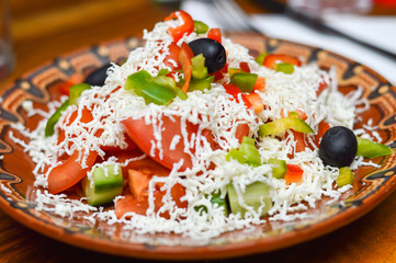 Picture of a traditional Bulgarian salad prepared from tomatoes, cucumbers, pepper and cheese.Shopska salad.