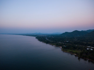 Aerial view of sea and beach with coconut palm tree on island at sunset time