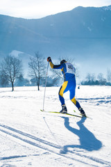 Athlete during an amateur cross country ski race in a sunny day
