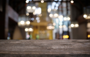Empty dark wooden table in front of abstract blurred bokeh background of restaurant . can be used for display or montage your products.Mock up for space.