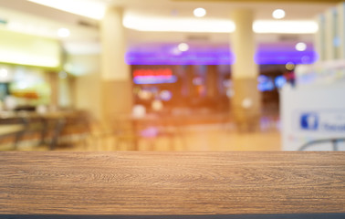 Empty dark wooden table in front of abstract blurred bokeh background of restaurant . can be used for display or montage your products.Mock up for space.