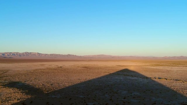 Aerial Lockdown: Big Shadow in Black Rock Desert of USA with the Sun Shining