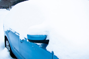 Snow on cars after snowfall. Winter urban scene.