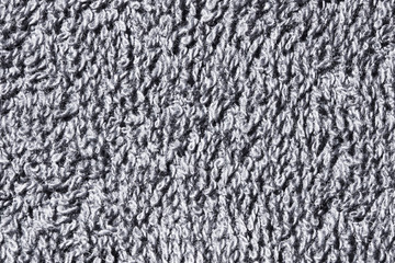 Soft and fluffy gray fiber towel closeup background pattern.