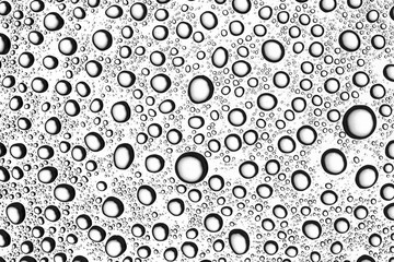 Transparent water drops on white glass surface background pattern. Natural circular shapes monochrome backdrop.
