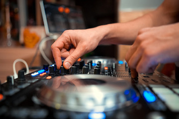 Fototapeta premium DJ console cd mp4 deejay mixing desk Ibiza house music party in nightclub with colored disco lights.