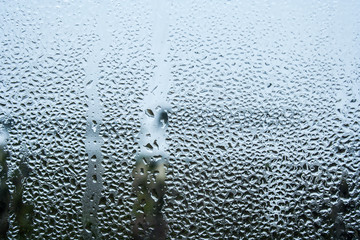 steamy glass. window covered with drops of water vapor