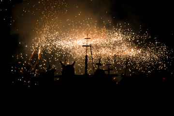 Ball de Diables street performance in Catalonia. Happy people dancing with some fireworks in a...