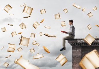 Man reading book and many of them flying in air