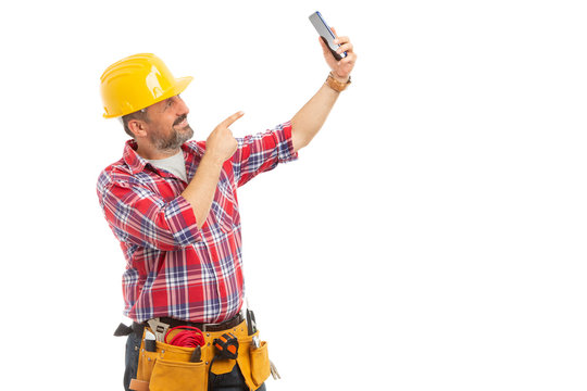 Construction worker taking selfie.