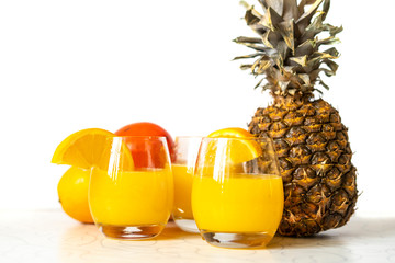 glass of fresh pineapple and orange smoothie on wood table isolated b