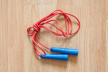 red and blue tied jumping rope isolated f