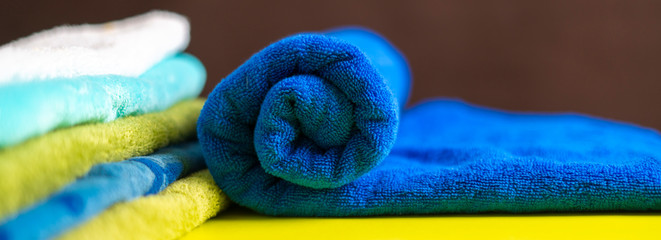 close up photo of rolled stack of colorful towels b