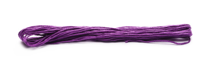 Purple string for sewing and knitting, isolated on white background