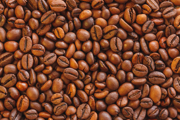 Closeup roasted brown coffee beans background.