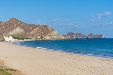Naklejka na ściany i meble Beautiful beach scene of Omani mountains and Gulf of Oman in the morning near Muscat, Oman.