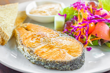 roasted salmon steak  or grilled salmon with vegetables  on white dish