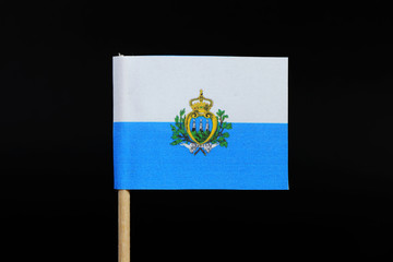 A official and national  flag of San Marino on toothpick on black background. A horizontal bicolour...