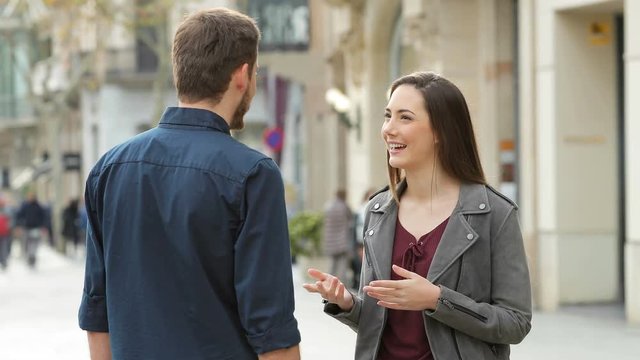 Happy man and woman handshaking after deal in the street