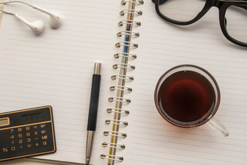 Pen, coffee, mobile glasses, headphones, calculators, put on notebooks