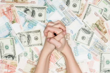 cropped view of female clenched hands on money background