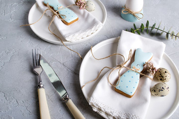 Homemade easter cookies in the shape of  a  funny  rabbit  on white plate. Easter  festive table setting. Holiday decorations.