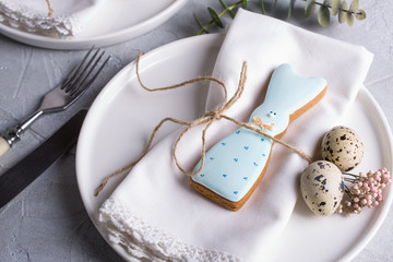 Homemade easter cookies in the shape of  a  funny  rabbit  on white plate. Easter  festive table setting. Holiday decorations.