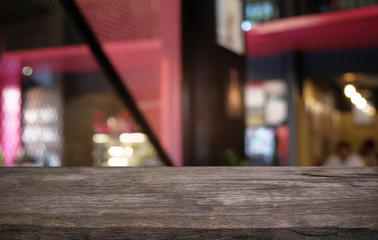 Empty dark wooden table in front of abstract blurred bokeh background of restaurant . can be used for display or montage your products.Mock up for space.