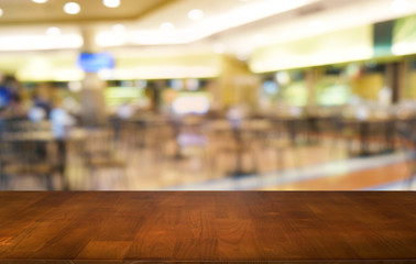 Empty dark wooden table in front of abstract blurred bokeh background of restaurant . can be used for display or montage your products.Mock up for space.