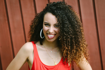 Young expressive curly hair pop girl making fun.