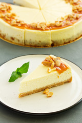Cheesecake with caramel and peanuts. Slice.