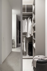 Modern wardrobe with sliding mirrored doors and luminous lamps
