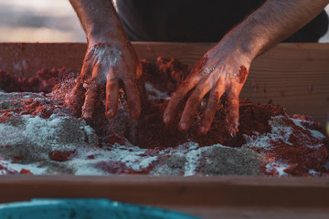 Hands kneading raw meat with spices to make sobrasada