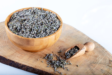 Dried lavender flowers in wooden bowl on white background