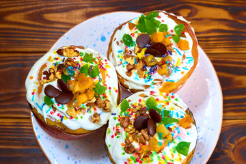 Three baked Easter cake, a traditional Russian Easter bread with meringue and colorful sprinkles